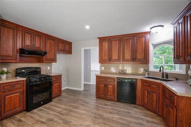 232 Barrett Springs Way, Canton, GA 30115 - kitchen featuring black appliances, under cabinet range hood, a sink, decorative backsplash, and light countertops