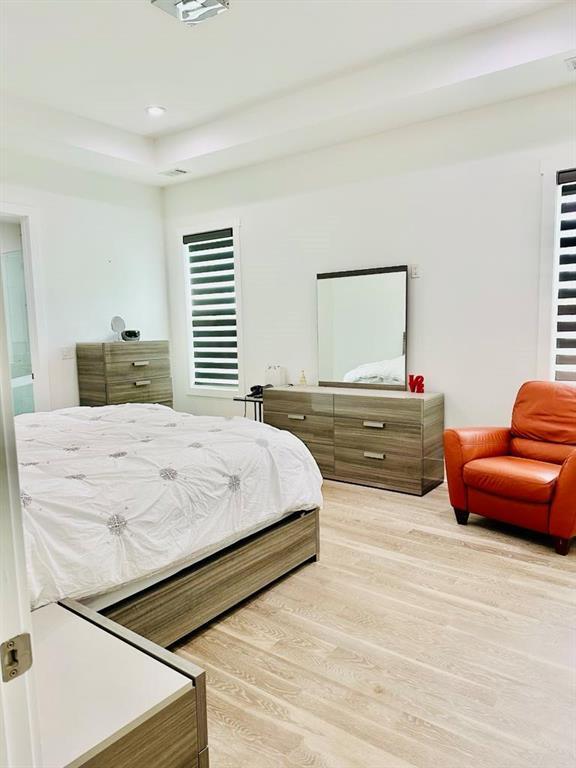 2964 Old Peachtree Rd, Dacula, GA 30019 - bedroom with recessed lighting, a raised ceiling, and light wood-style flooring