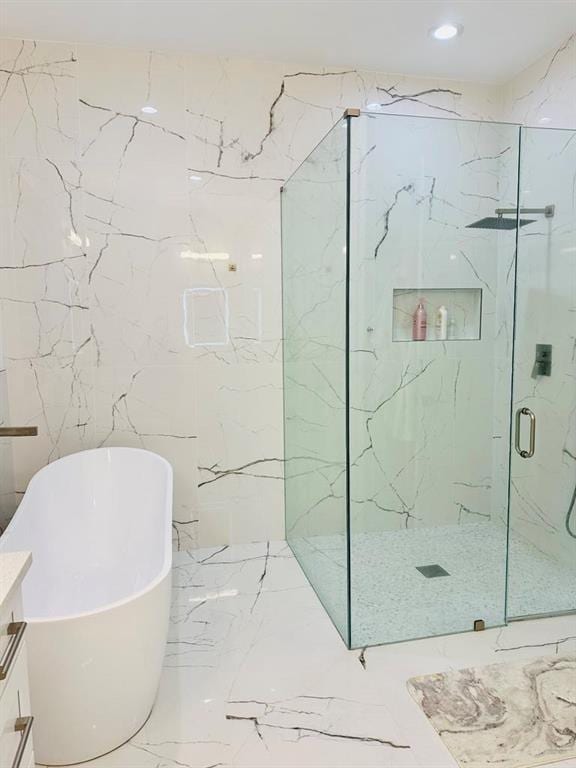 2964 Old Peachtree Rd, Dacula, GA 30019 - full bathroom featuring a freestanding tub, vanity, marble finish floor, a marble finish shower, and recessed lighting