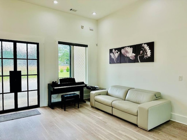 2964 Old Peachtree Rd, Dacula, GA 30019 - living area with a towering ceiling, visible vents, baseboards, light wood-style floors, and recessed lighting