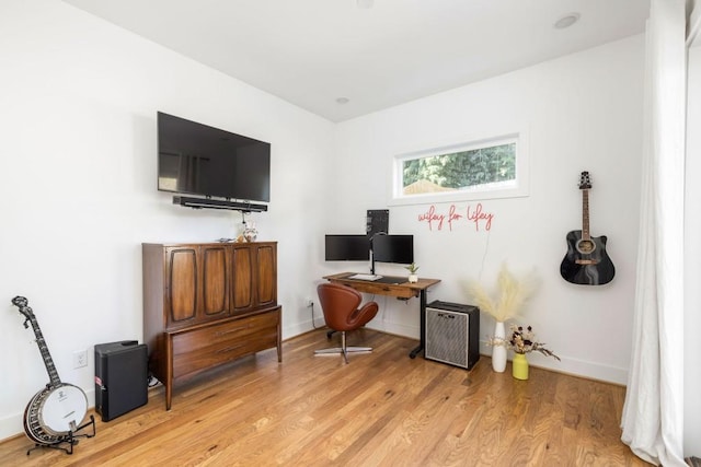 office space featuring light wood-style flooring and baseboards