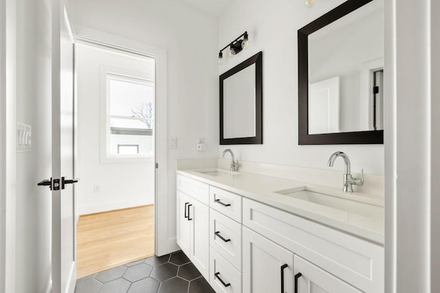 bathroom featuring a sink, double vanity, and tile patterned flooring