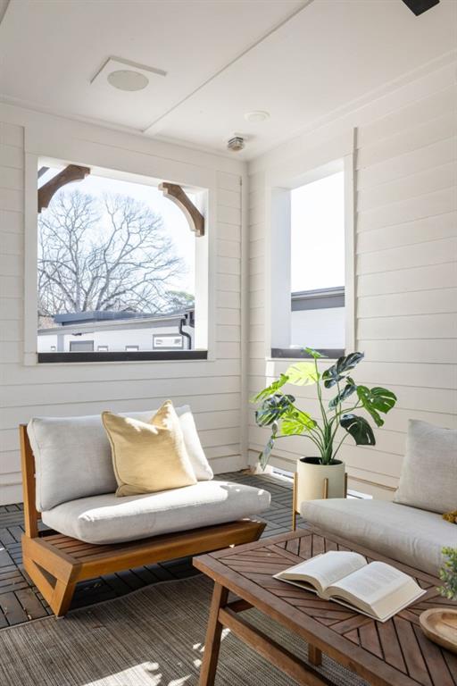 living room with a wealth of natural light and wood walls