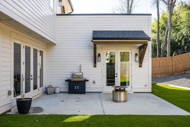 view of patio with french doors and fence