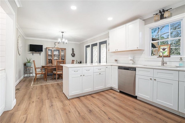 kitchen with sink, white cabinetry, crown molding, plenty of natural light, and dishwasher