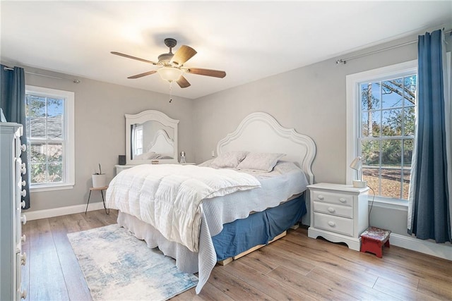 bedroom with light hardwood / wood-style floors and ceiling fan