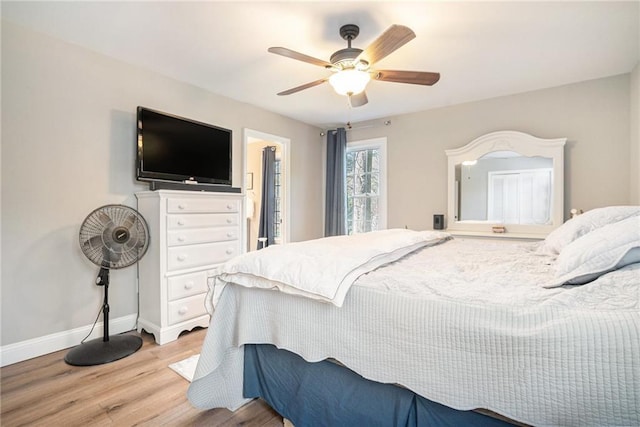 bedroom with ceiling fan and light hardwood / wood-style flooring