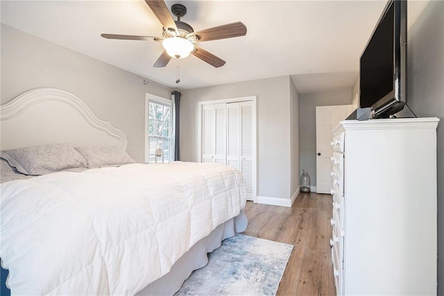 bedroom featuring ceiling fan, a closet, and light hardwood / wood-style flooring