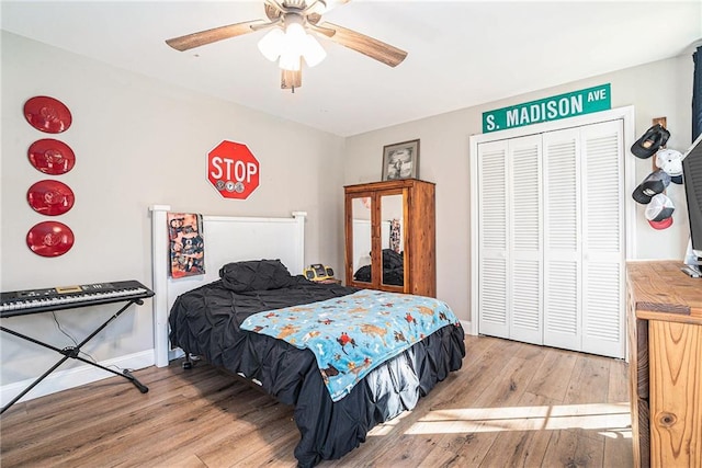 bedroom with light hardwood / wood-style flooring, a closet, and ceiling fan