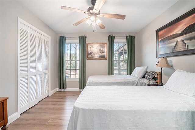 bedroom featuring light hardwood / wood-style flooring, a closet, and ceiling fan