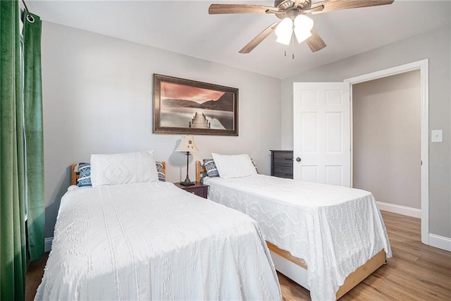 bedroom with light hardwood / wood-style floors and ceiling fan