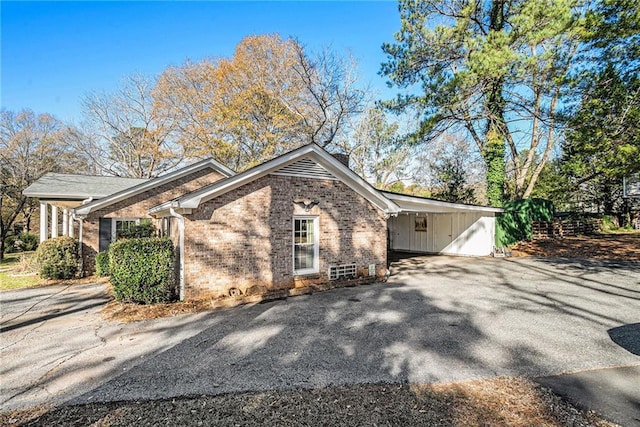 view of side of home with a carport