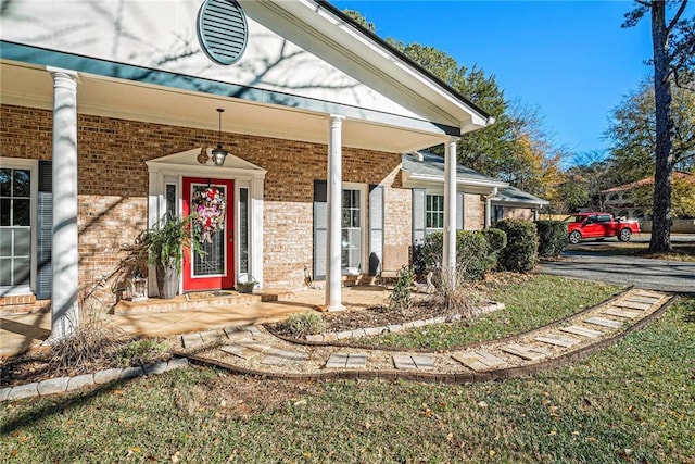 view of exterior entry featuring a porch