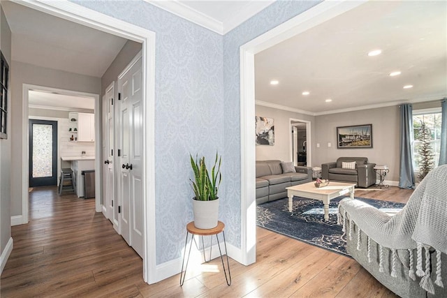 corridor with crown molding and hardwood / wood-style floors