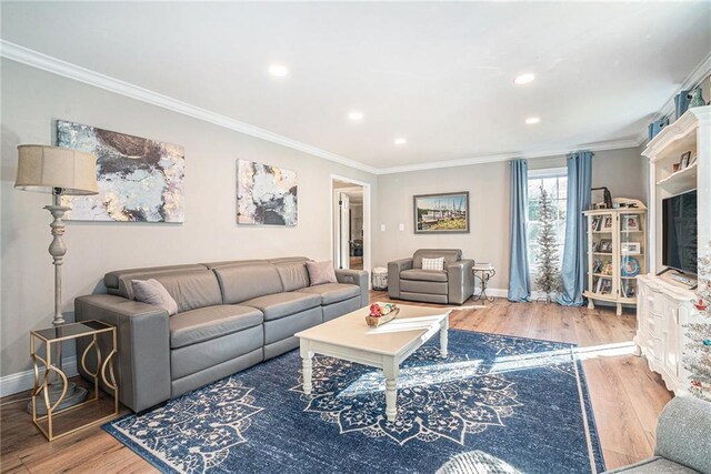 living room with crown molding and hardwood / wood-style flooring