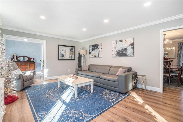 living room with crown molding, wood-type flooring, and a chandelier