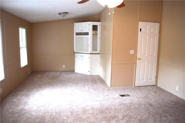 59 Pine Ridge Ln, White, GA 30184 - carpeted spare room featuring a decorative wall, a textured ceiling, and ceiling fan