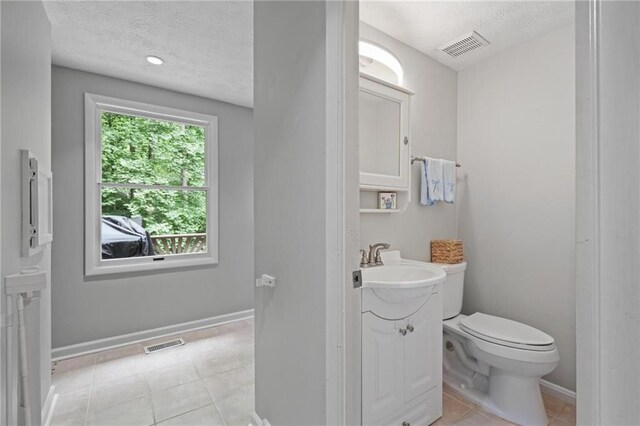 9470 Hillside Dr, Roswell, GA 30076 - half bathroom with a textured ceiling, vanity, and tile patterned floors
