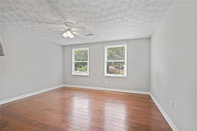 9470 Hillside Dr, Roswell, GA 30076 - empty room with wood finished floors, ceiling fan, and a textured ceiling
