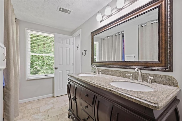 9470 Hillside Dr, Roswell, GA 30076 - full bath featuring double vanity and a textured ceiling