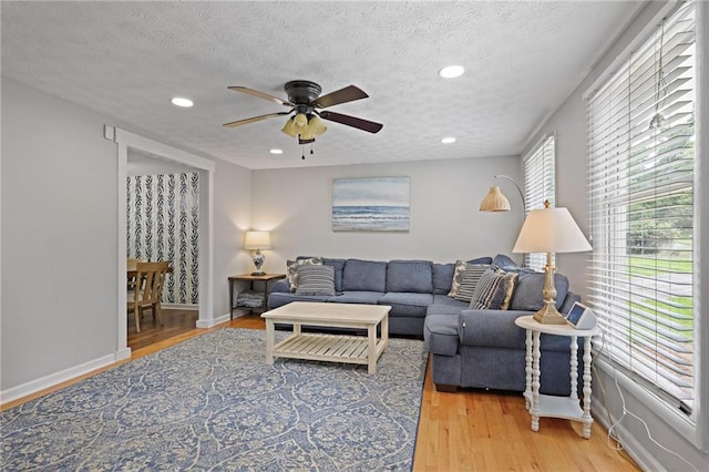9470 Hillside Dr, Roswell, GA 30076 - living room featuring a ceiling fan, light wood-type flooring, recessed lighting, and a textured ceiling