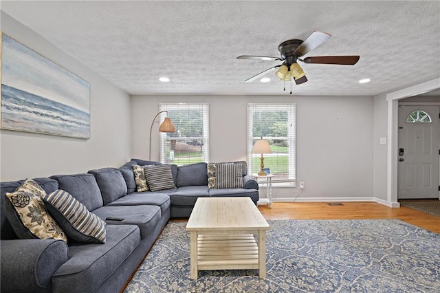 9470 Hillside Dr, Roswell, GA 30076 - living room featuring wood finished floors, ceiling fan, recessed lighting, and a textured ceiling