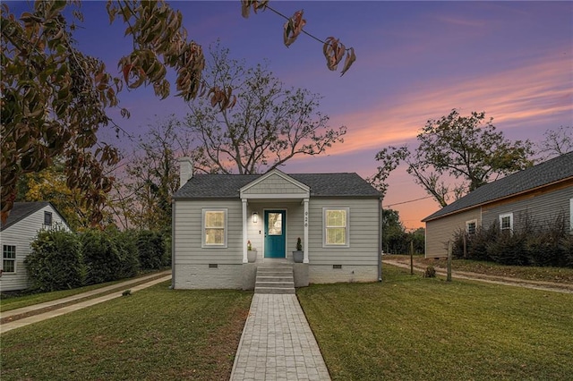 bungalow-style house featuring a yard