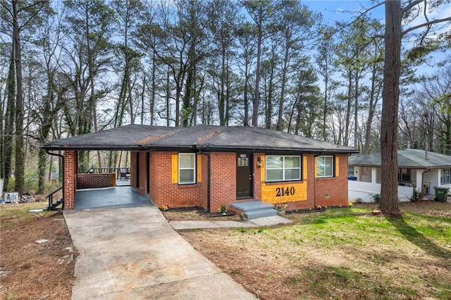 view of front of house with a carport, crawl space, brick siding, and concrete driveway