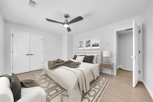 bedroom featuring ceiling fan, a closet, and light wood-type flooring