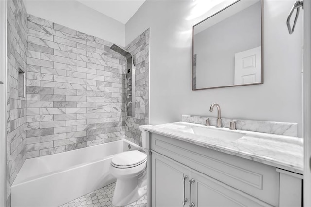 full bathroom with tile patterned floors, toilet, vanity, and tiled shower / bath