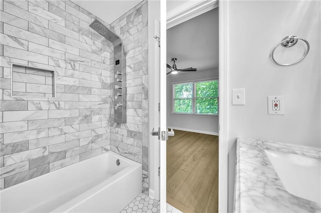 bathroom featuring tile patterned floors, vanity, ceiling fan, and tiled shower / bath