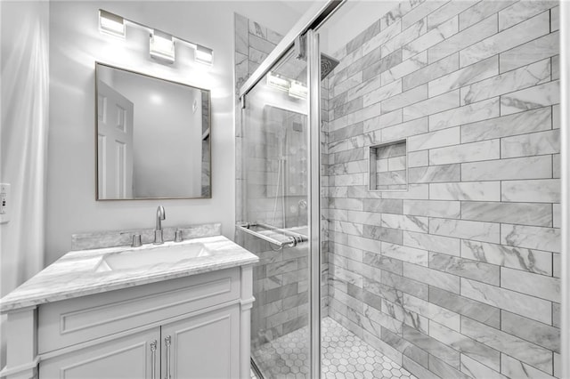 bathroom featuring vanity and an enclosed shower