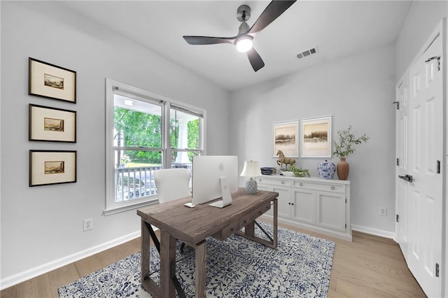 office space featuring light wood-type flooring and ceiling fan