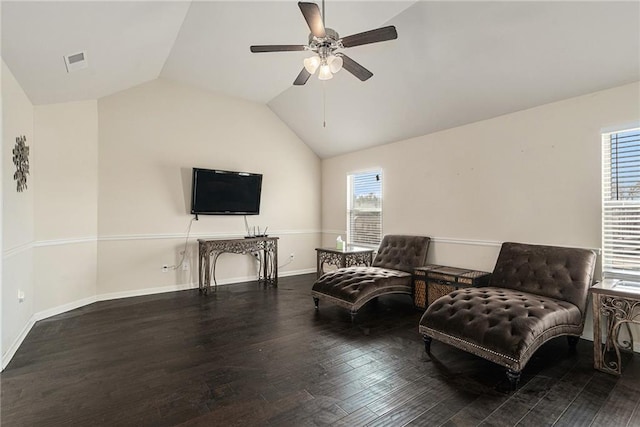 living area with a healthy amount of sunlight, ceiling fan, hardwood / wood-style floors, and vaulted ceiling