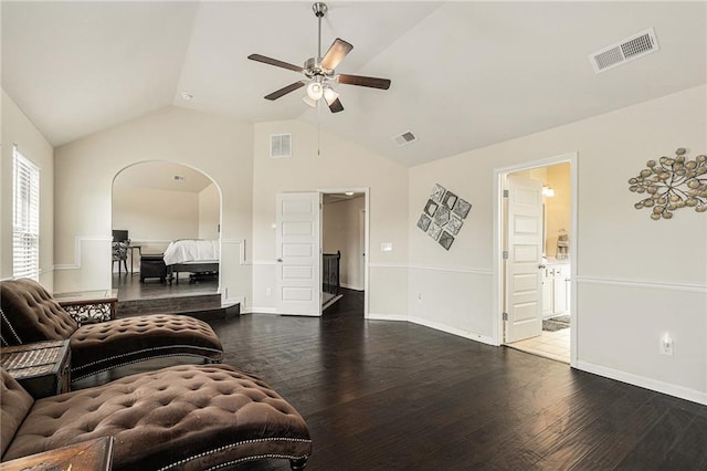 living room with dark hardwood / wood-style flooring, ceiling fan, and vaulted ceiling