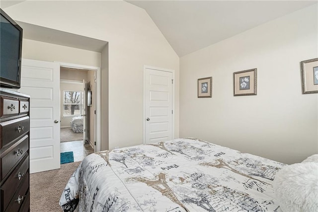 bedroom featuring vaulted ceiling and carpet floors