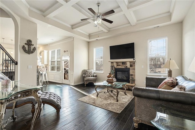 living room featuring a fireplace, ceiling fan, coffered ceiling, and plenty of natural light