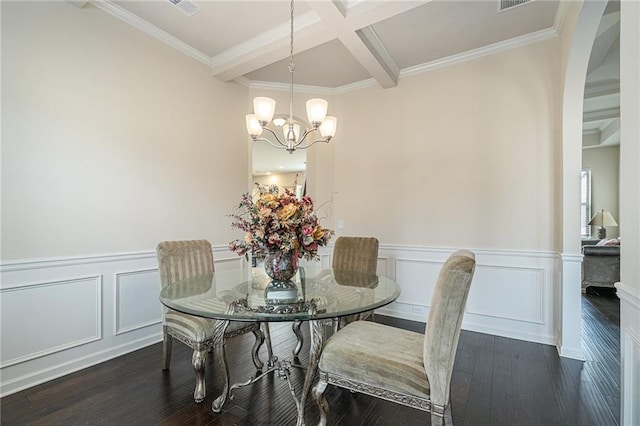 dining area featuring a chandelier, beam ceiling, crown molding, and dark wood-type flooring