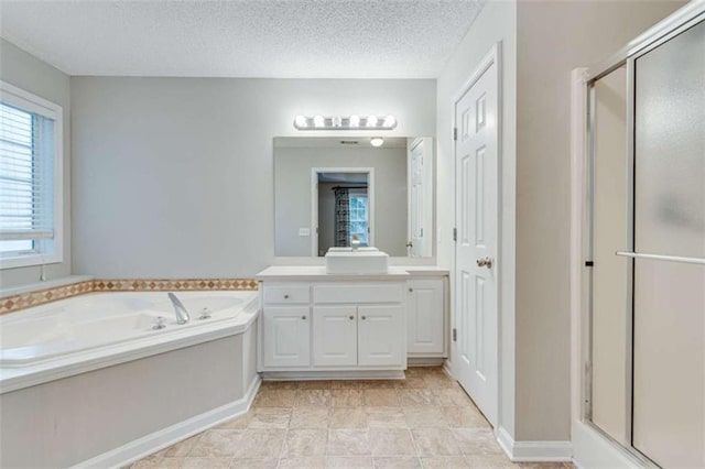 1227 Casper Ln, Winder, GA 30680 - bathroom featuring a shower stall, vanity, a bath, and a textured ceiling