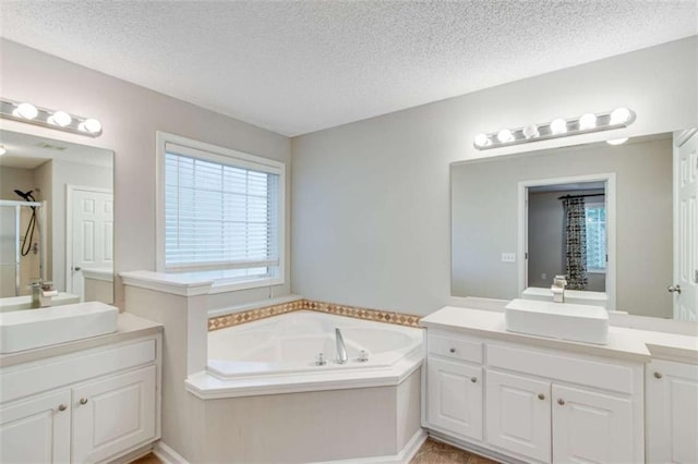 1227 Casper Ln, Winder, GA 30680 - bathroom featuring an enclosed shower, two vanities, a garden tub, and a textured ceiling