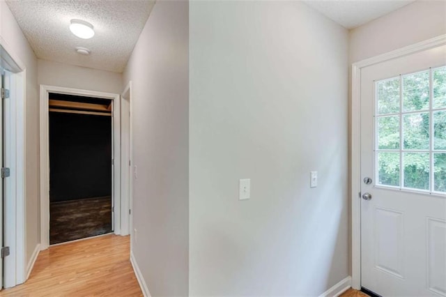 1227 Casper Ln, Winder, GA 30680 - doorway featuring plenty of natural light, light wood finished floors, a textured ceiling, and baseboards