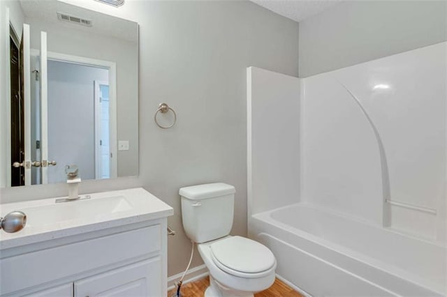 1227 Casper Ln, Winder, GA 30680 - full bathroom with toilet, vanity, baseboards, wood finished floors, and shower / washtub combination