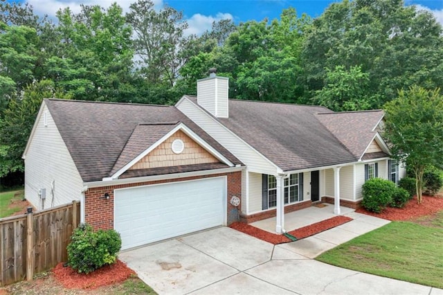1227 Casper Ln, Winder, GA 30680 - view of front of property with a garage, brick siding, a porch, and concrete driveway