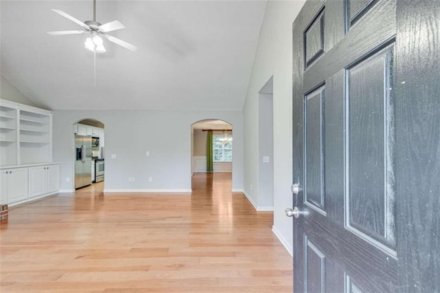 1227 Casper Ln, Winder, GA 30680 - foyer with arched walkways, a ceiling fan, light wood finished floors, baseboards, and high vaulted ceiling