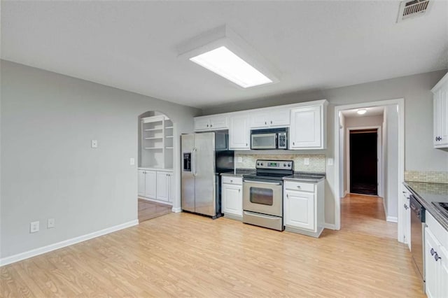 1227 Casper Ln, Winder, GA 30680 - kitchen featuring stainless steel appliances, light wood-type flooring, decorative backsplash, and white cabinetry