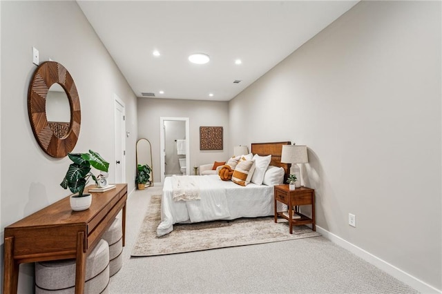 carpeted bedroom featuring ensuite bathroom