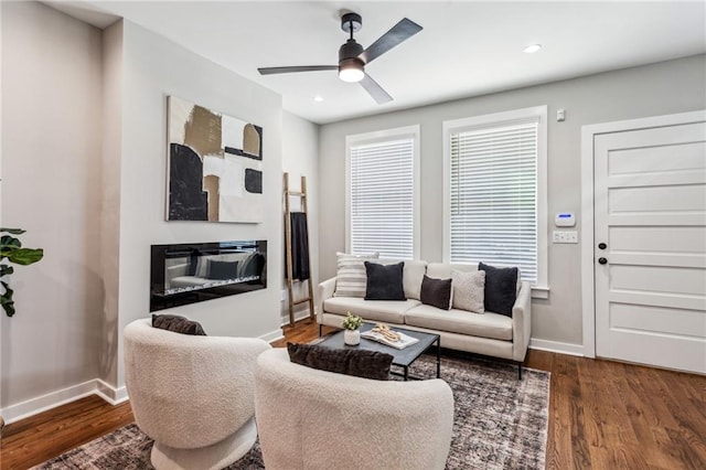 living room featuring hardwood / wood-style flooring and ceiling fan