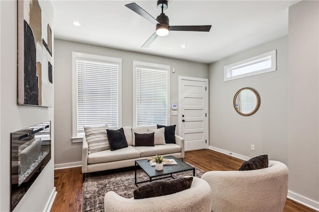 living room featuring dark hardwood / wood-style flooring and ceiling fan