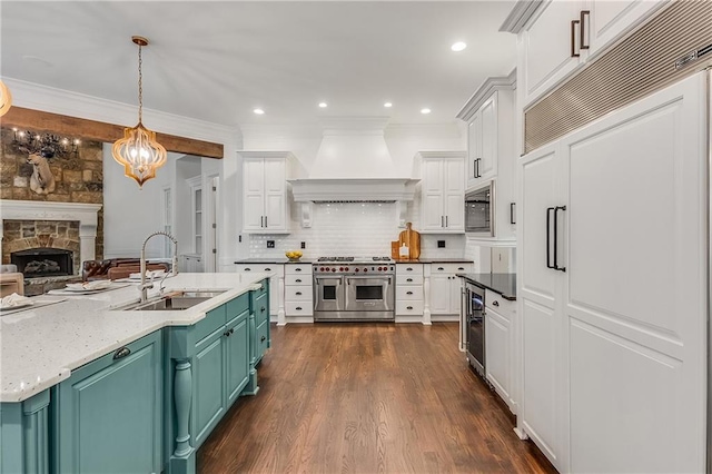 kitchen featuring wine cooler, white cabinetry, a sink, built in appliances, and premium range hood