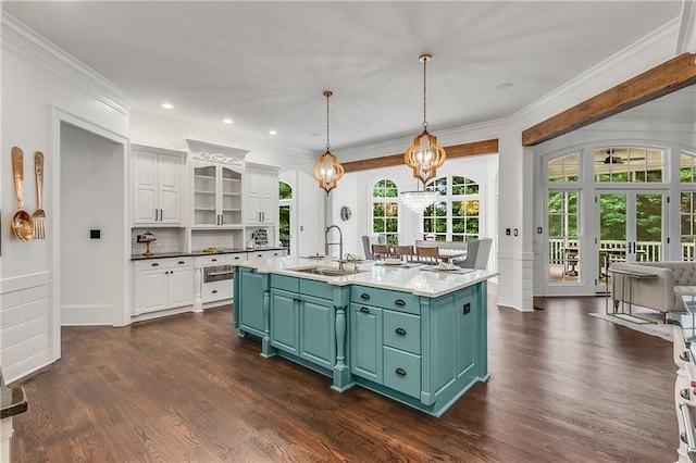 kitchen featuring crown molding, dark wood-style flooring, white cabinets, and a sink